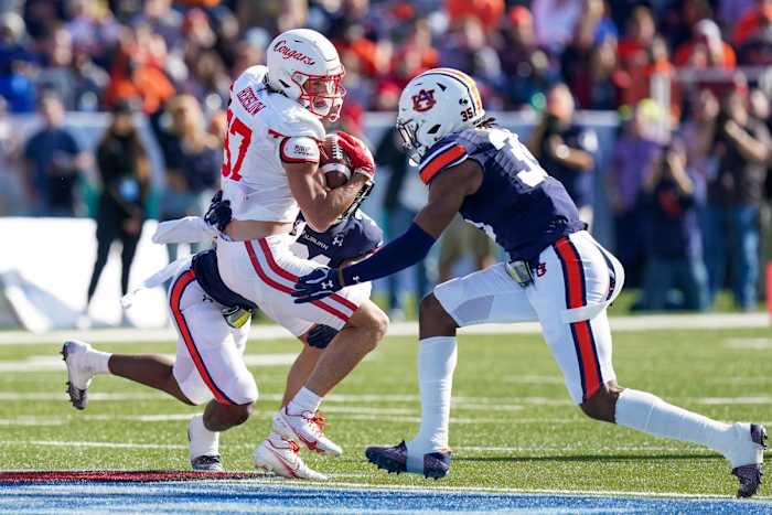 Dec 28, 2021; Birmingham, Alabama, USA; Houston Cougars wide receiver Jake Herslow (87) is tackled by Auburn Tigers linebacker Chandler Wooten (31) and Auburn Tigers linebacker Cam Riley (35) during the first half of the 2021 Birmingham Bowl at Protective Stadium. Mandatory Credit: Marvin Gentry-USA TODAY Sports